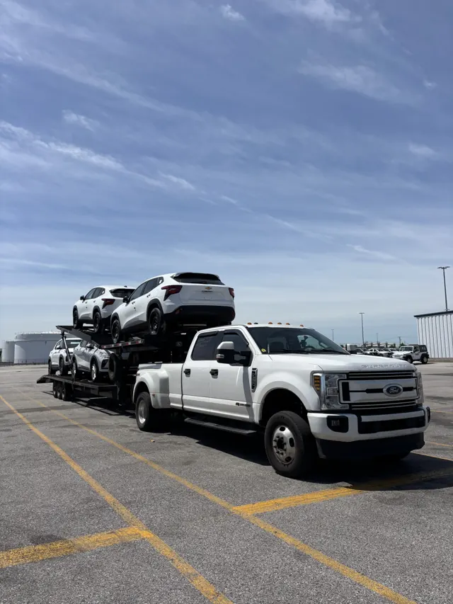 Loaded car hauler in a parking lot in clear daylight